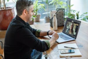 Hiring manager of tech company taking online interview of candidate.