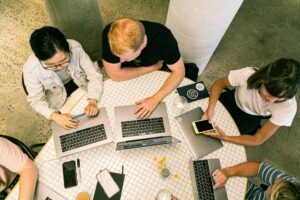 Top view of diverse team collaboratively working in a modern office setting.